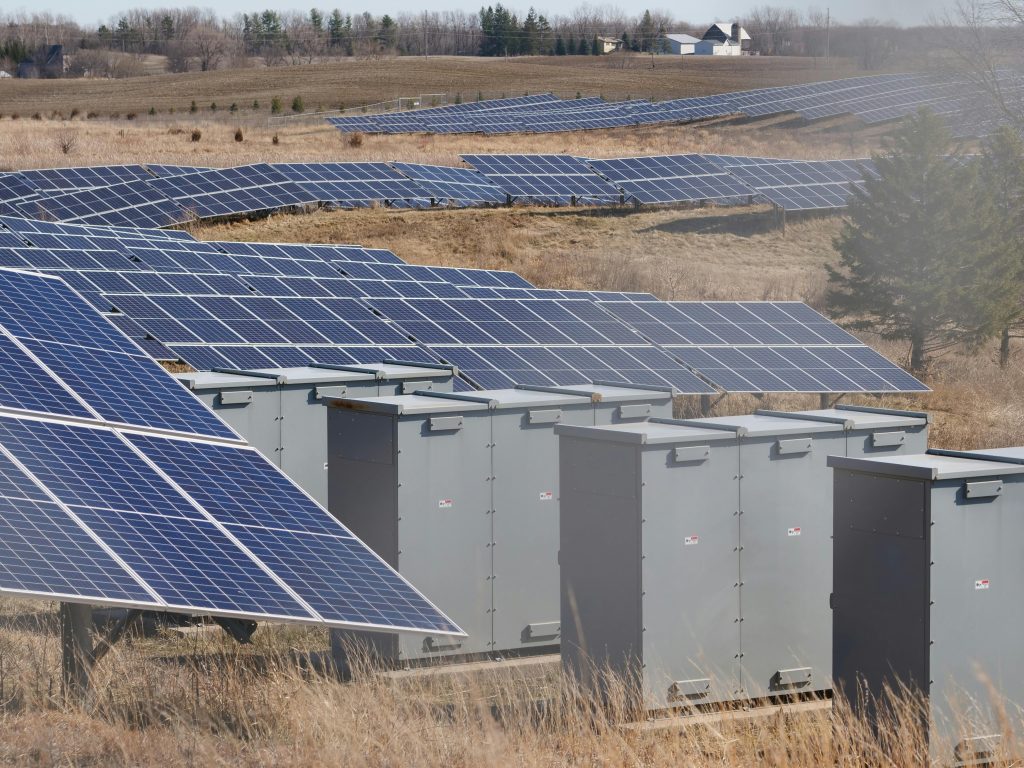 Expansive solar panel field in a rural area harnessing solar energy. Sustainable and renewable energy source.